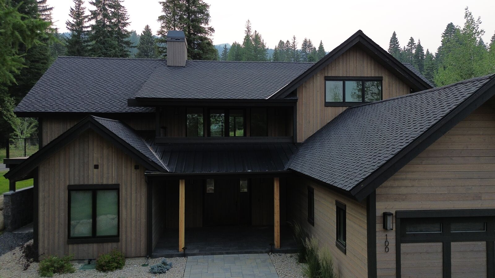 Mountain modern home with new dark shingles and metal accents in Donnelly Idaho — Blue Goat Roofing